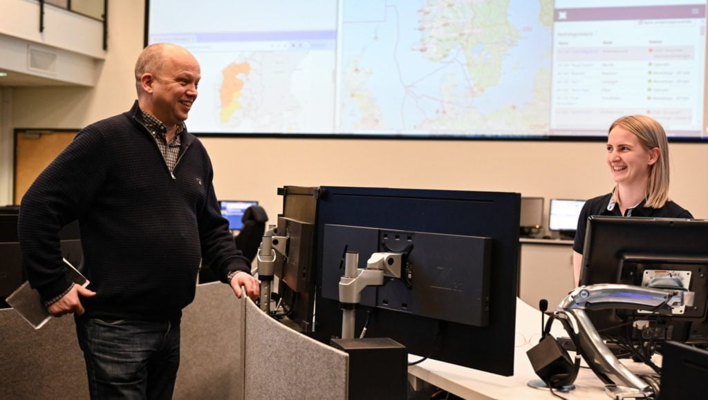 Mann snakker med kvinne i en operasjonssentral