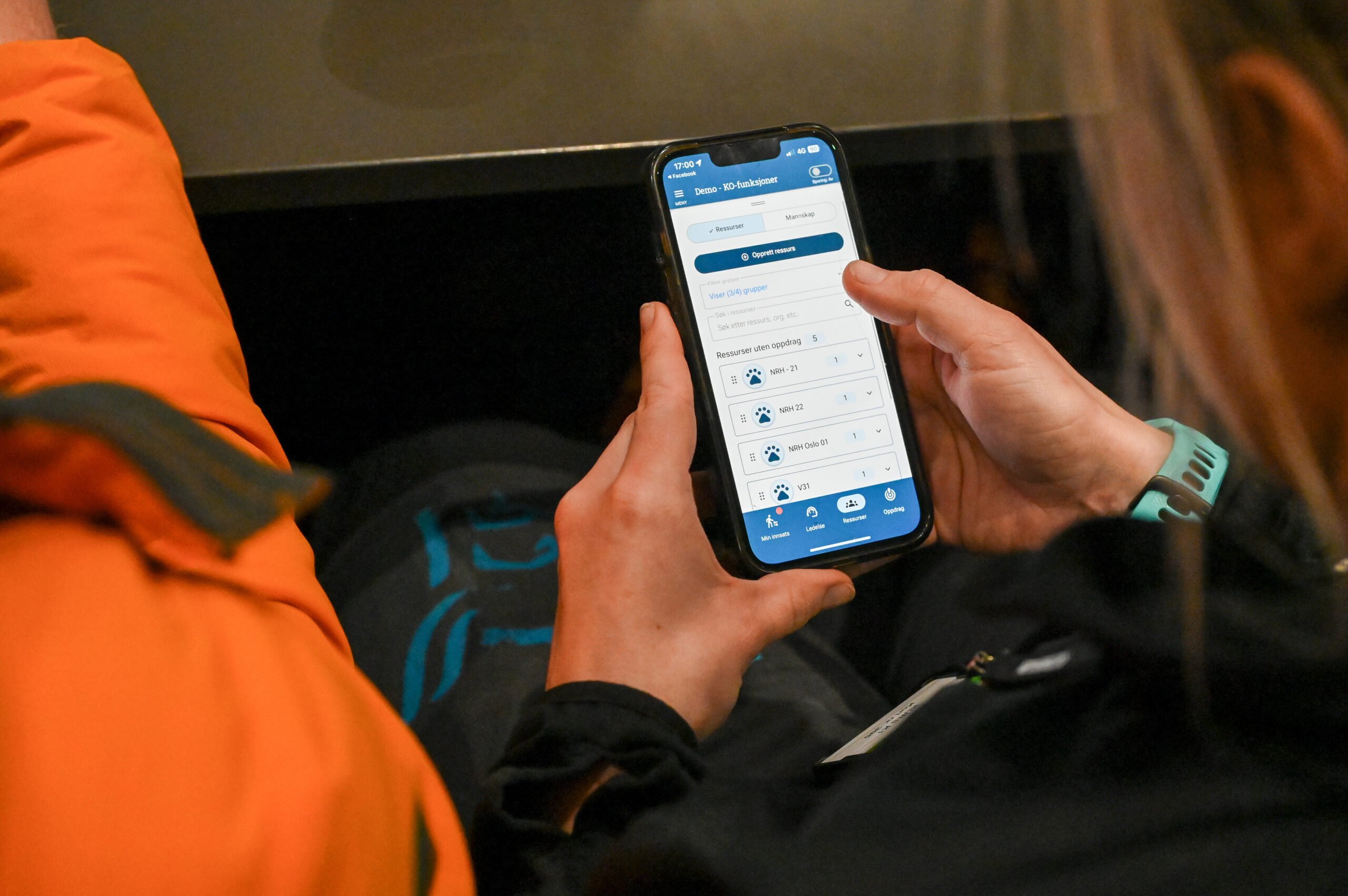 En kvinne holder en mobiltelefon og man ser demonstrasjon av et støtteverktøy på mobilen.